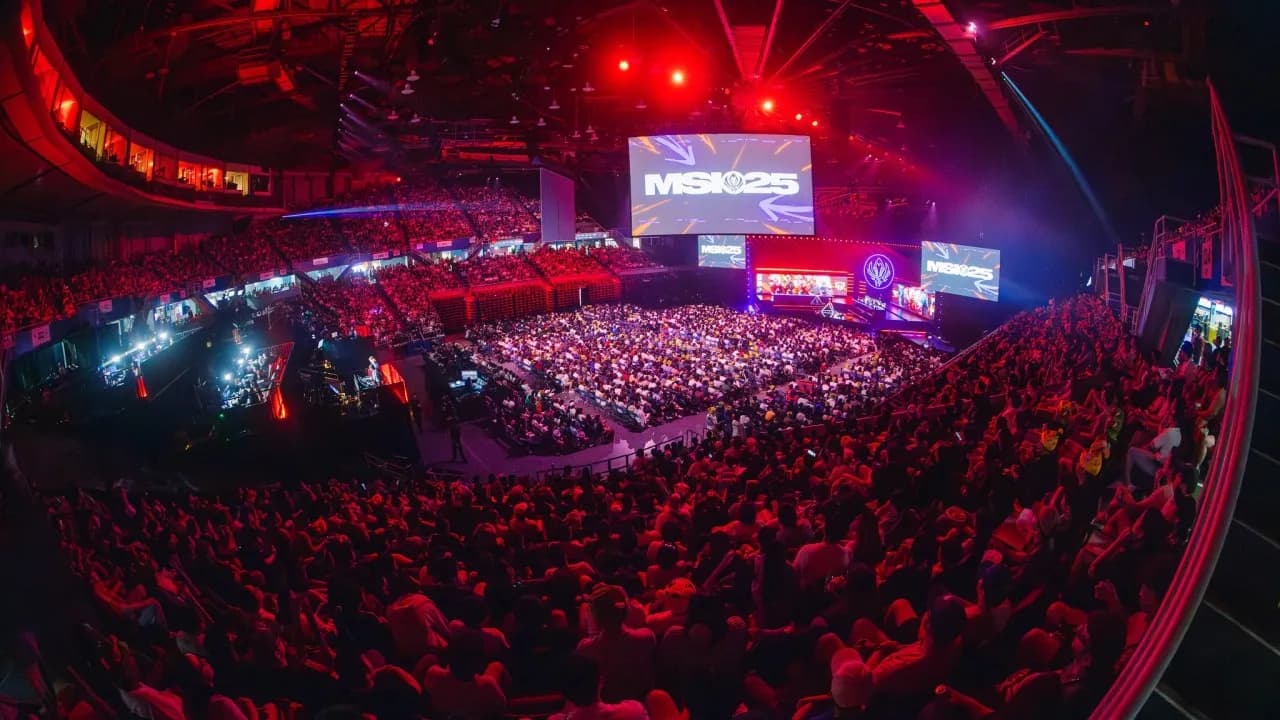 A packed, red-lit arena at the League of Legends Mid-Season Invitational 2025