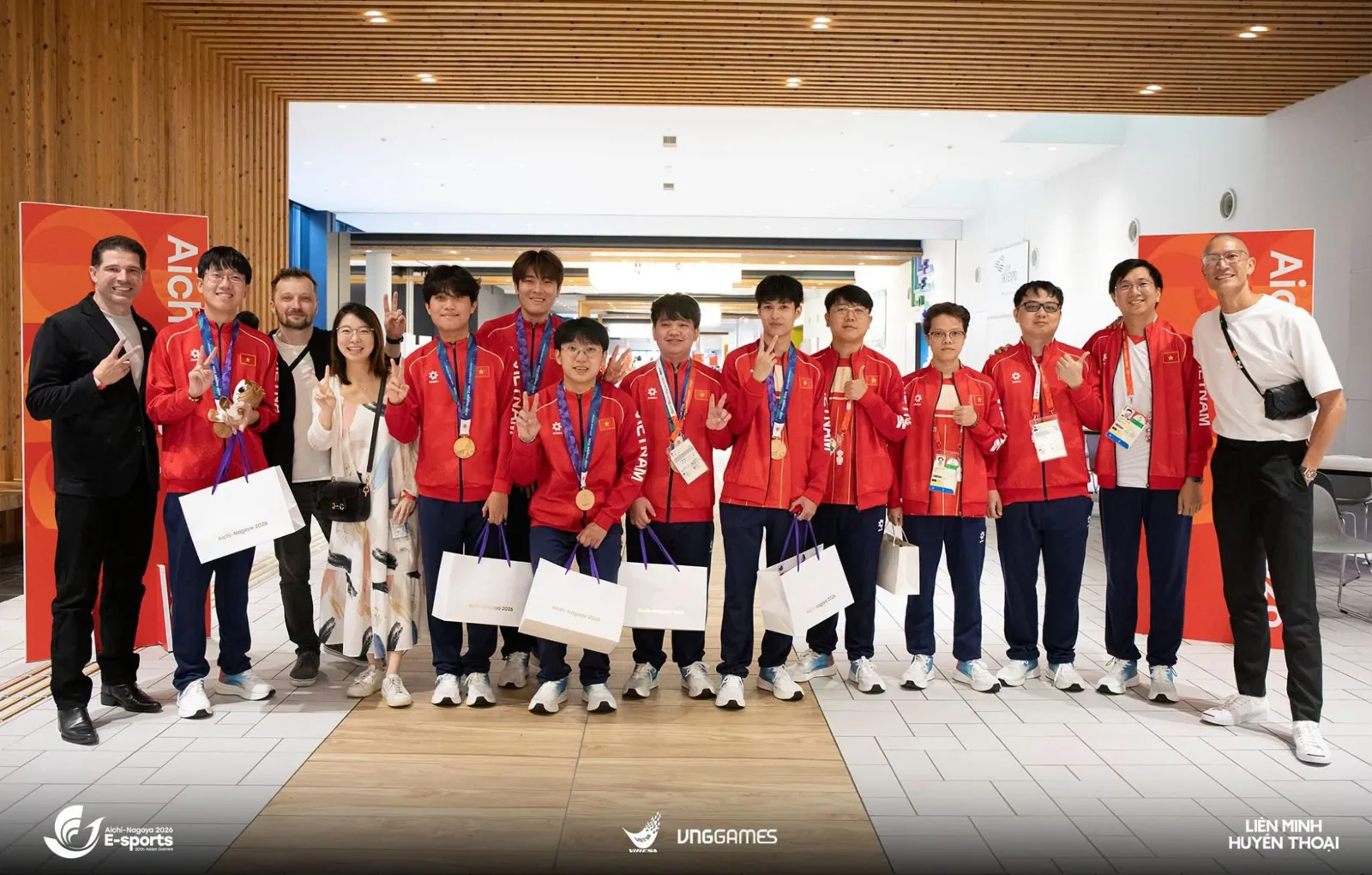 Team Vietnam's League of Legends players and staff in red team jackets with their bronze medals at the 2026 Asian Games in Aichi-Nagoya