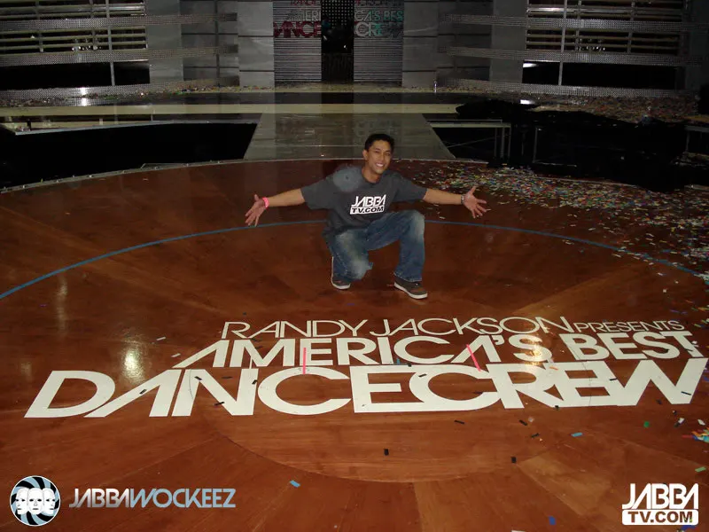 TK Nguyen kneeling on the America's Best Dance Crew stage, confetti behind him, after the Season 1 finale