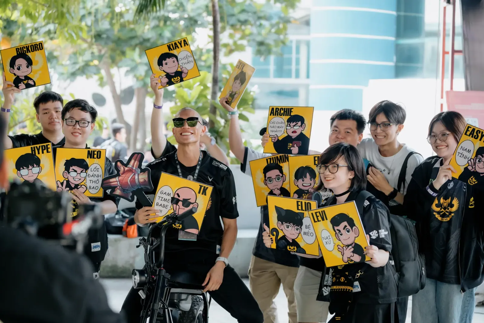 The GAMFAM holding up player signs for TK, Levi, Kiaya and the team