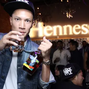 TK Nguyen raising a glass at a Hennessy event as a brand ambassador