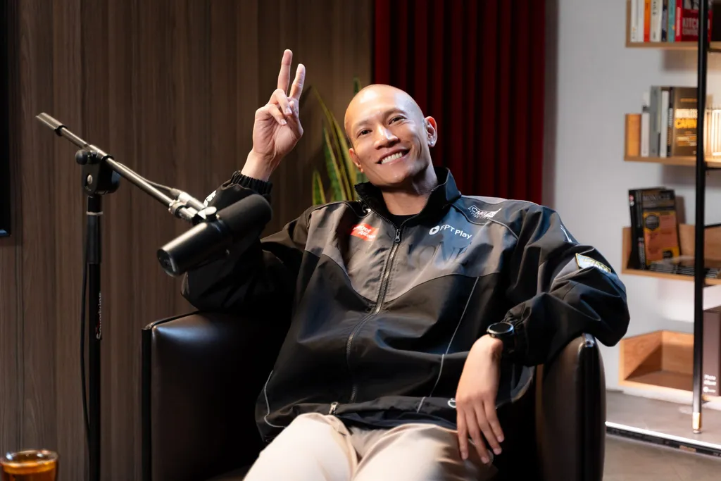 TK Nguyen, CEO of GAM Entertainment, smiling and making a peace sign in the GAM Changers podcast studio