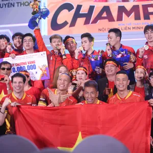 Team Vietnam's League of Legends squad celebrating SEA Games 31 gold with the Vietnamese flag, 2022